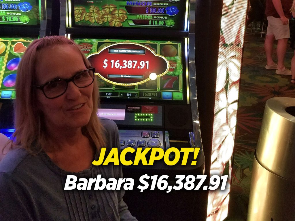 A woman sitting in front of a slot machine.