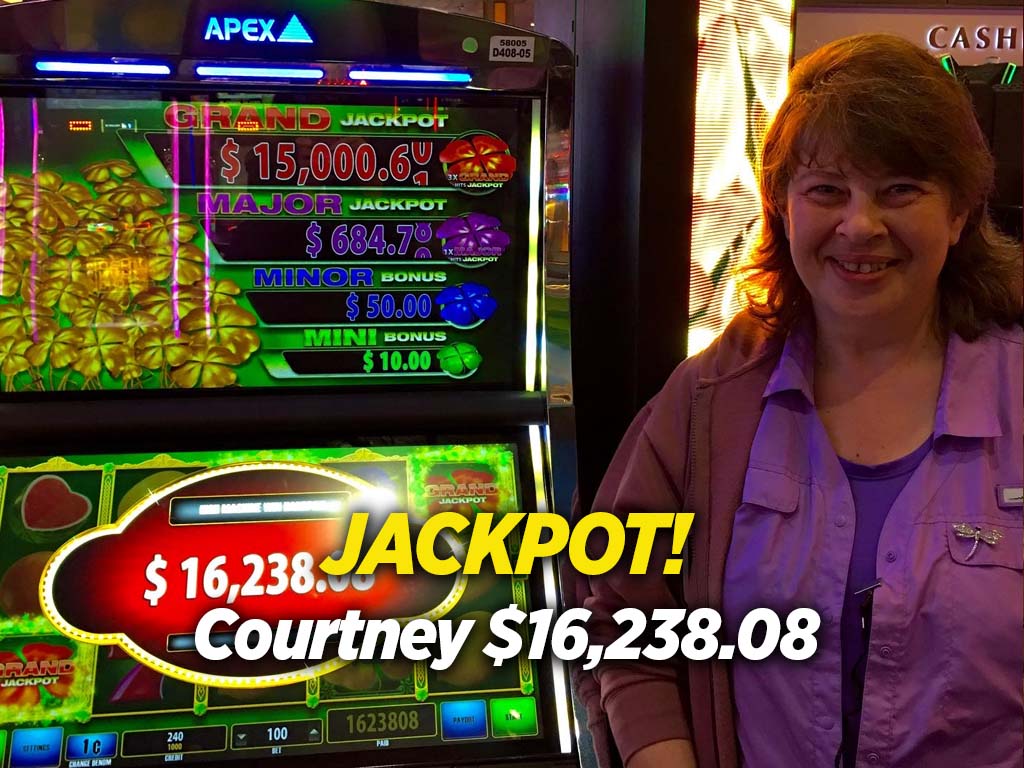 A woman standing in front of a slot machine.