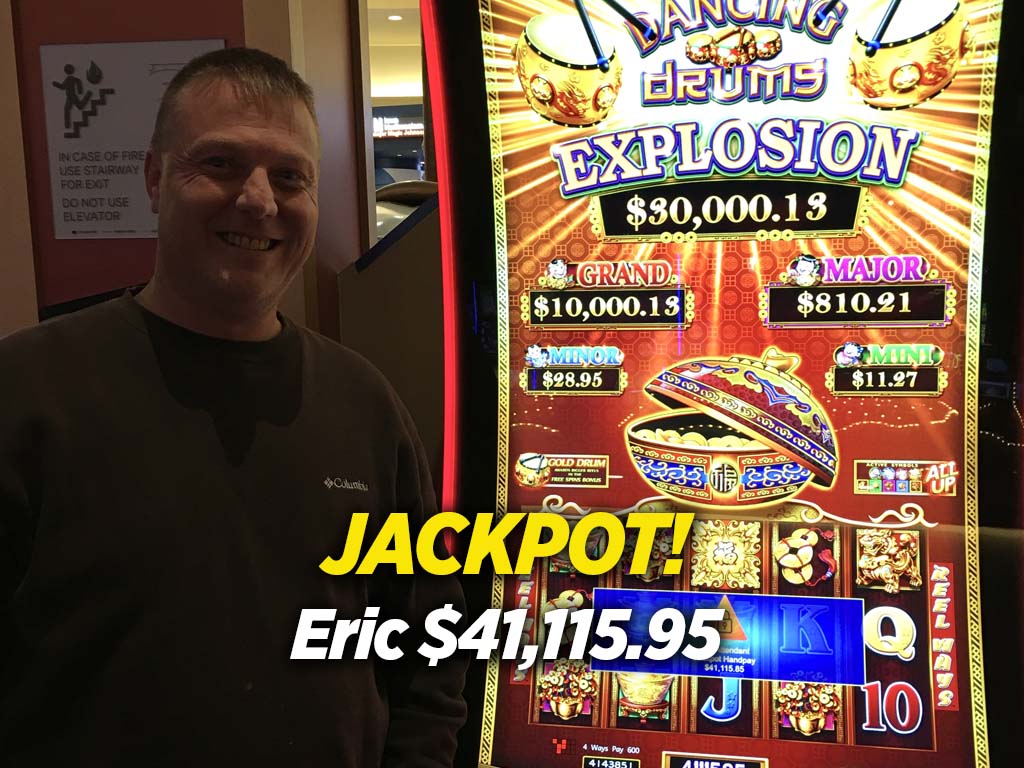 A man standing in front of a slot machine.