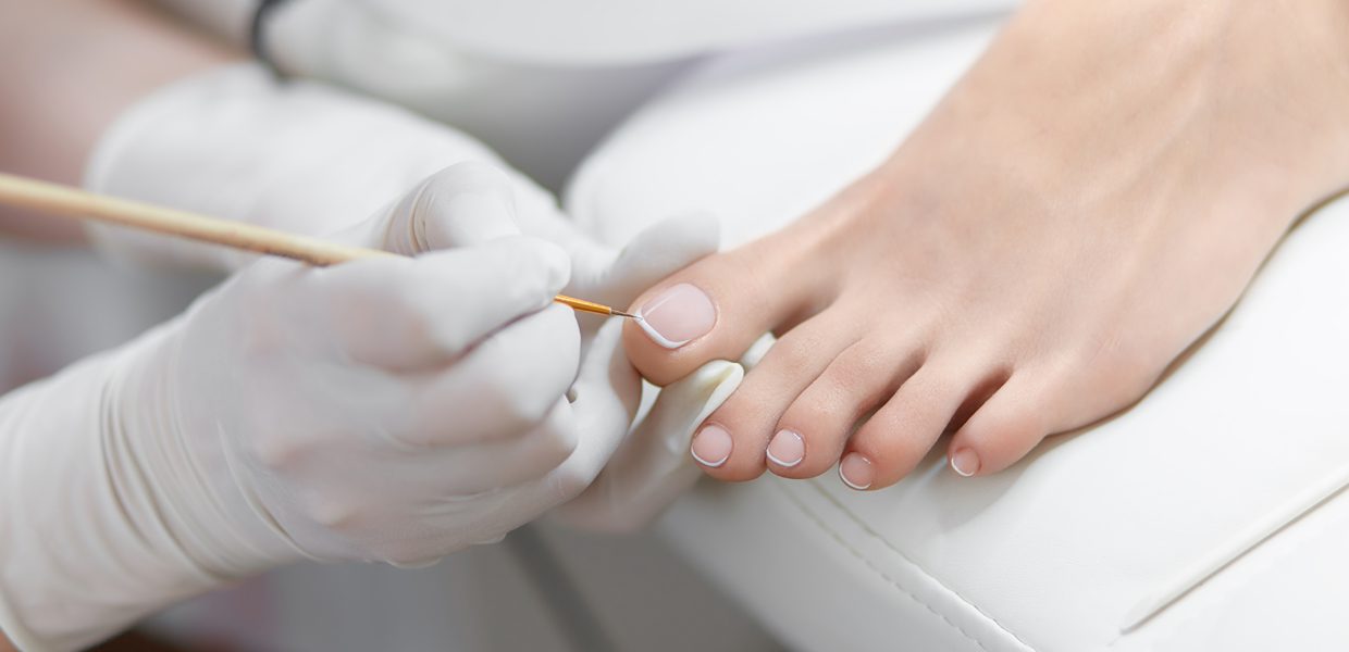 A person getting their nails done by someone.