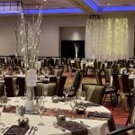 A banquet hall with tables and chairs set up for an event.