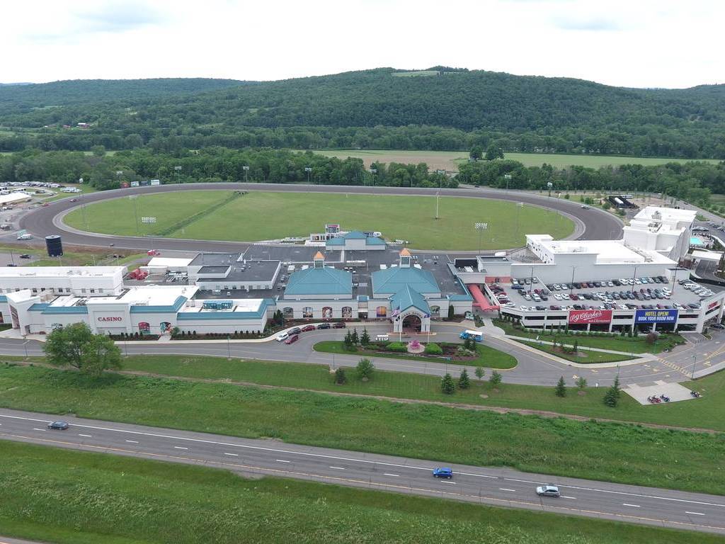 An aerial view of a large school with a field in the background.