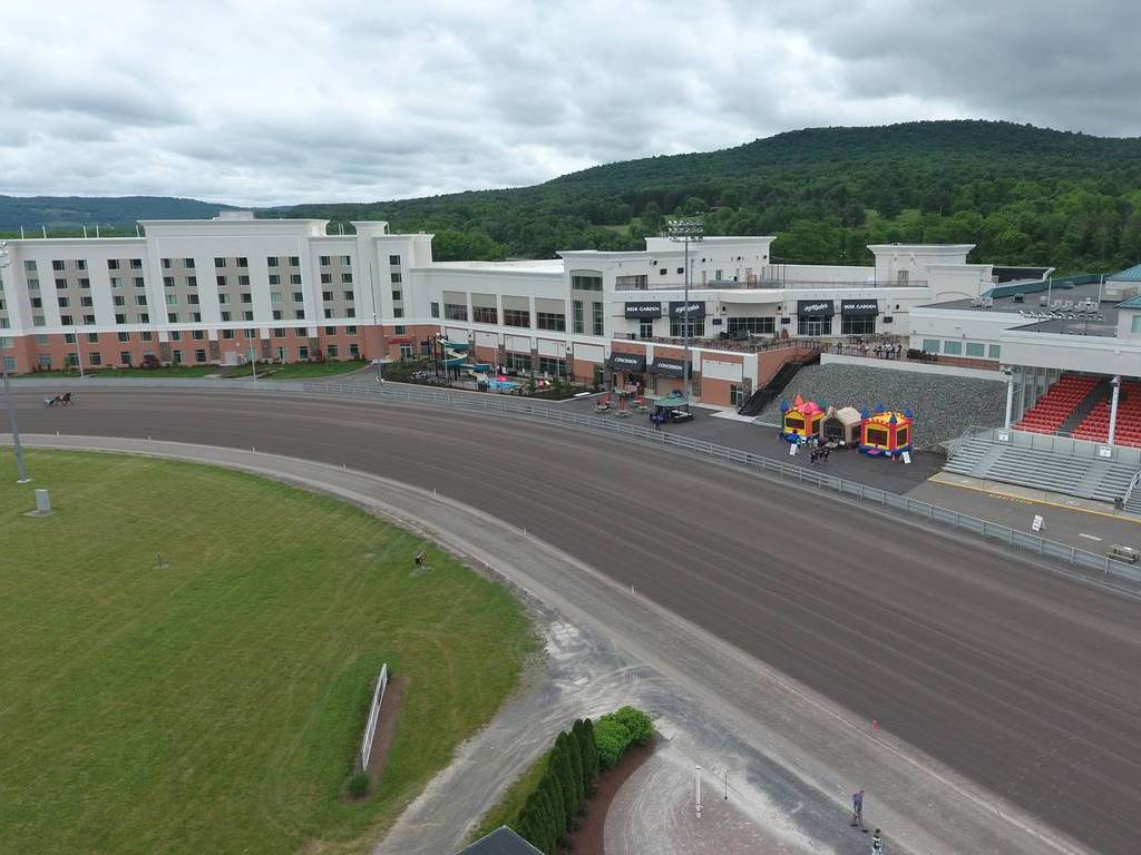 A large building with construction equipment on the ground.