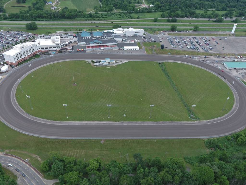 An aerial view of a race track with cars parked in the lot.