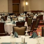 A room with many tables and chairs in it