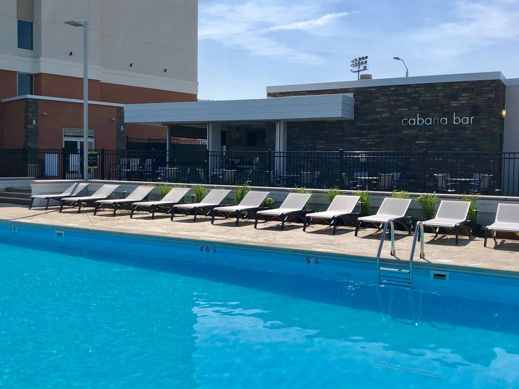 A pool with many chairs in the middle of it