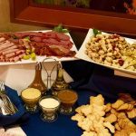 A table filled with plates of food and sauces.