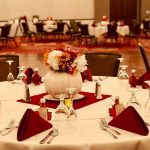A table set with red napkins and silverware.