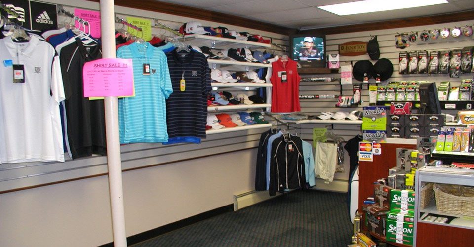 A store with several racks of clothing and shoes.