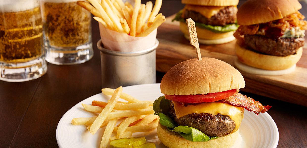 A hamburger and french fries on a plate.