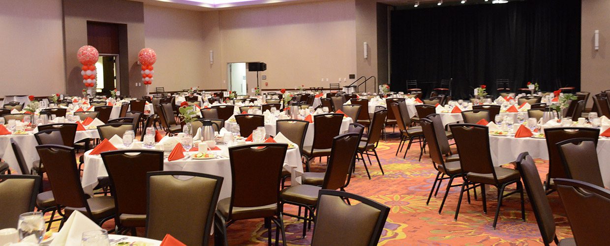 A room with many tables and chairs in it