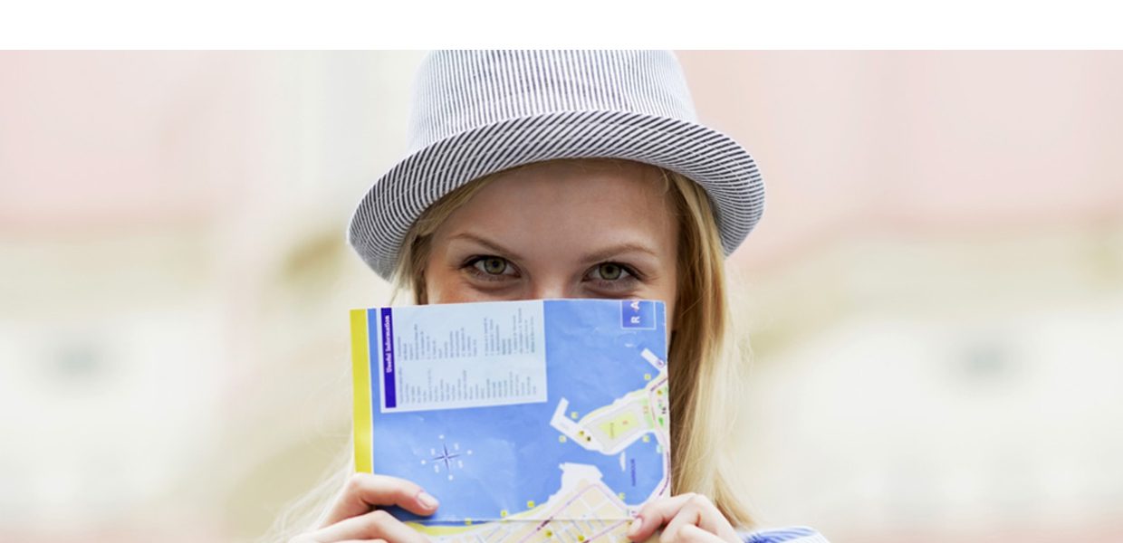 A woman holding up a book with the cover of it.