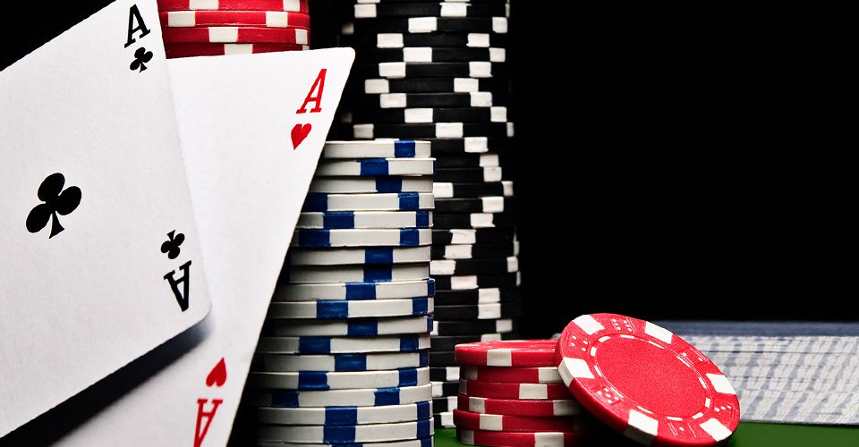 A stack of poker chips and cards on top of each other.