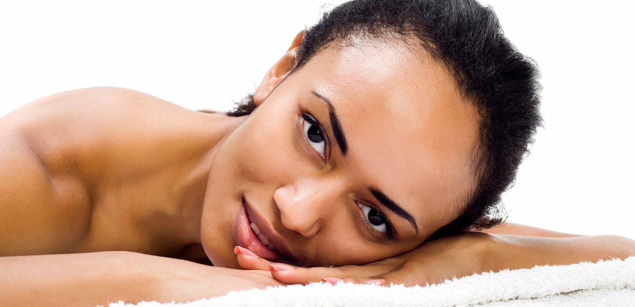 A woman laying on her side with her eyes closed.